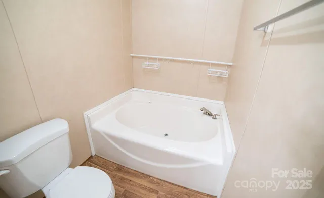 a white toilet sitting next to a white sink