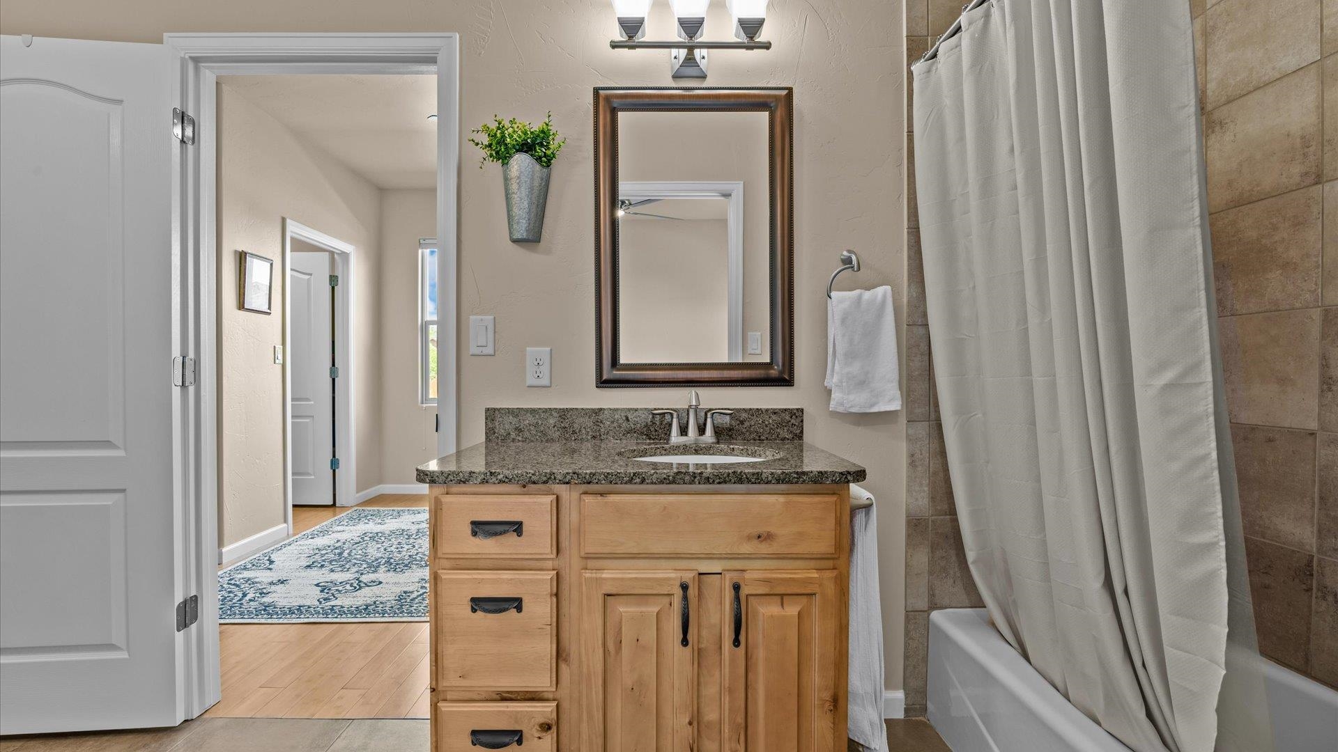 1712 Powis Lane Fruita, CO 81521 - Photo 26 of 39 a bathroom with a granite countertop sink and a mirror
