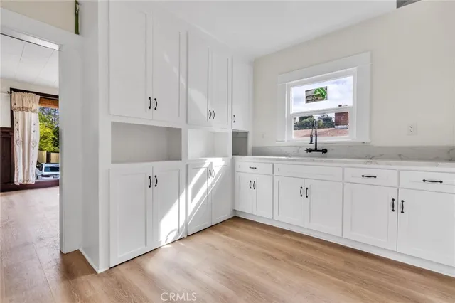 a kitchen with a sink and wooden cabinets