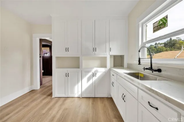 a view of a room with wooden floor and cabinet