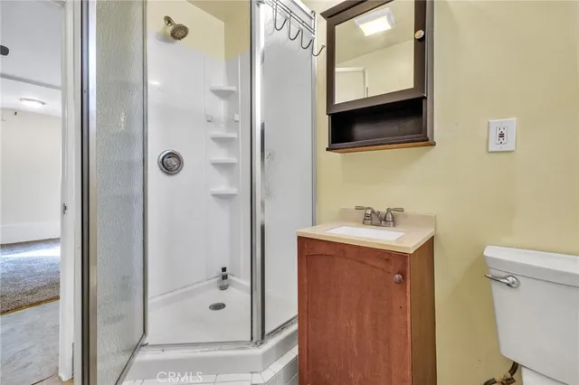 a view of a roof deck with a table and chairs under an umbrella
