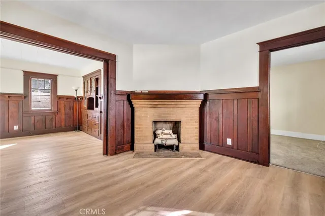a view of a livingroom with a fireplace and window