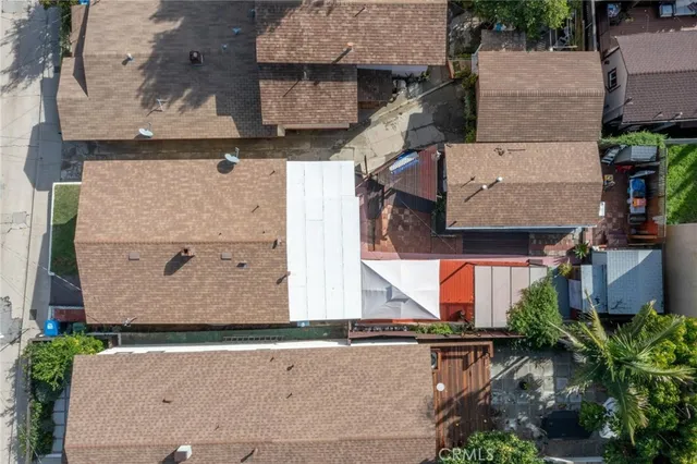 an aerial view of residential building with parking and yard