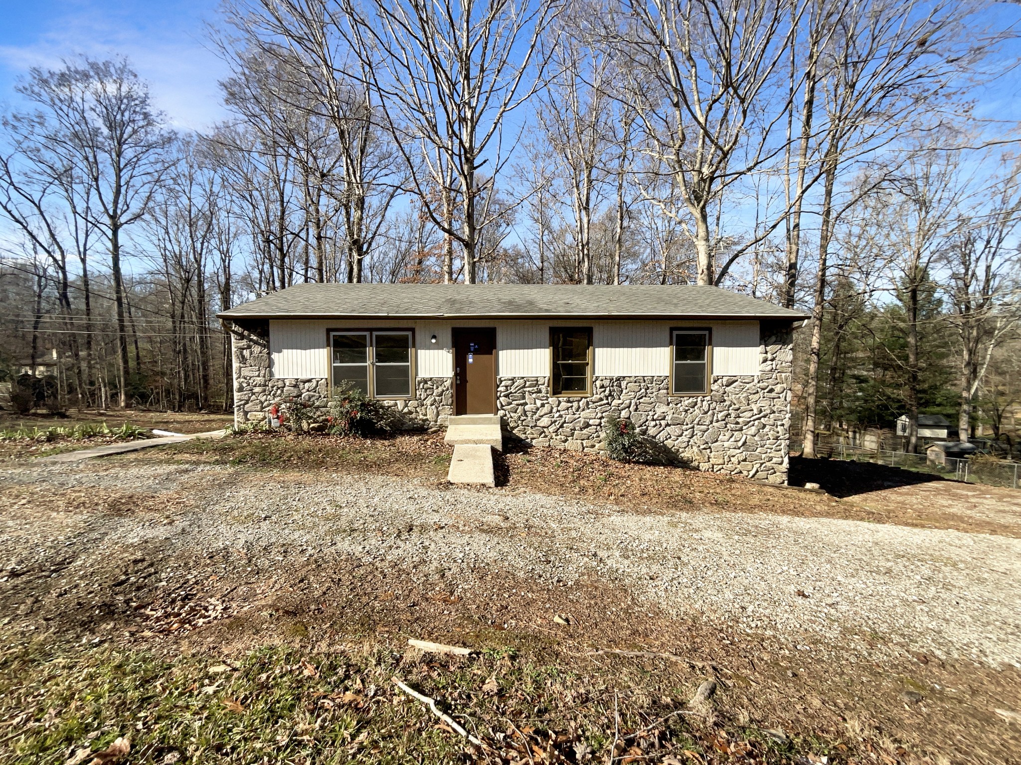 401 Cedarview Drive Dickson, TN 37055 - Photo 1 of 19 a front view of a house with a yard covered with snow and trees