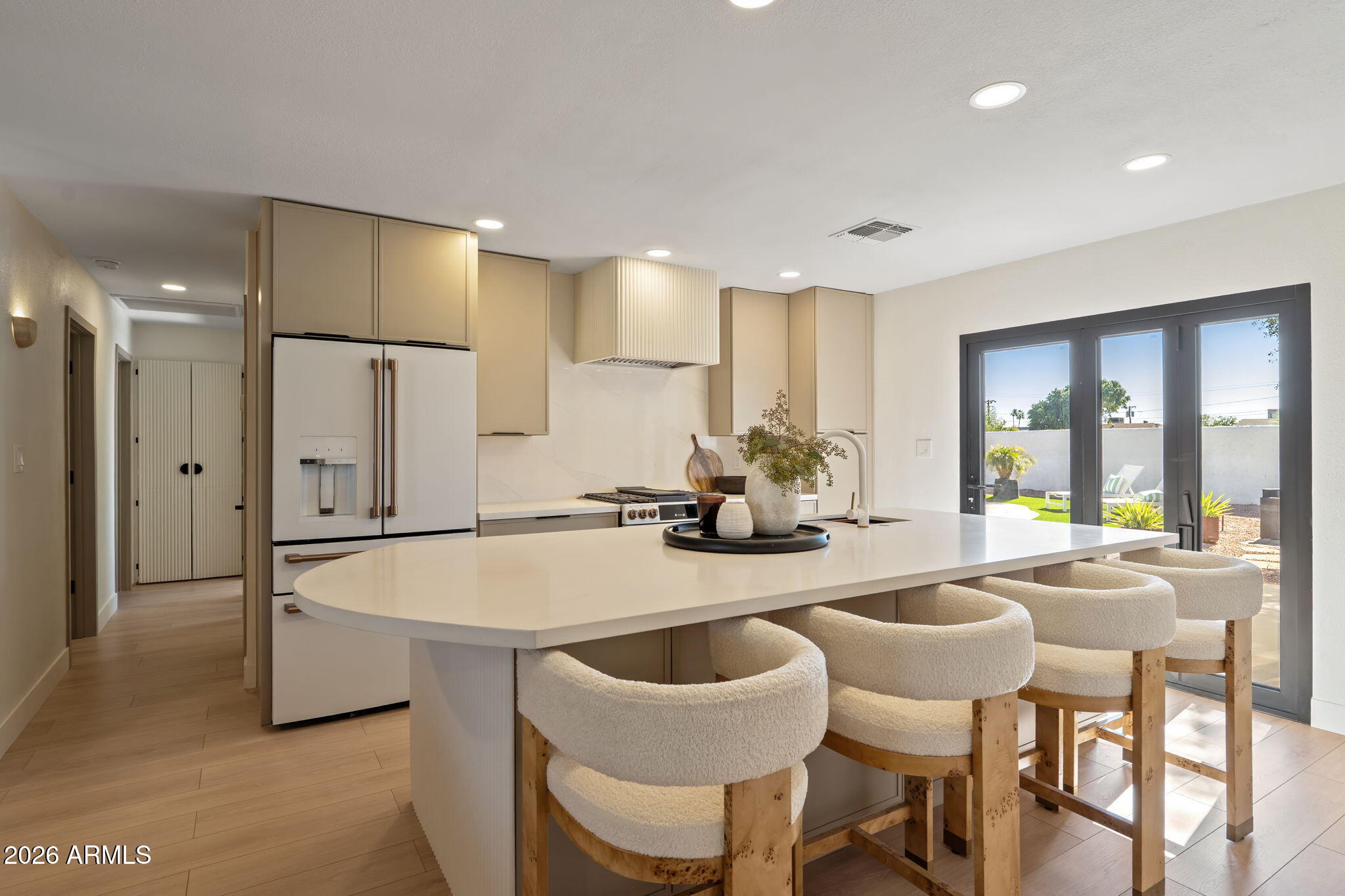 7255 East Coronado Road Scottsdale, AZ 85257 - Photo 10 of 55 a kitchen with a dining table chairs and refrigerator