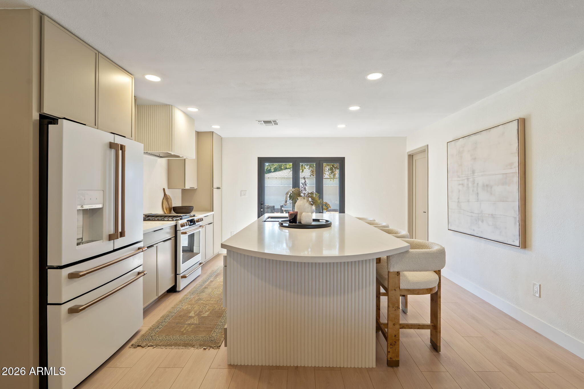 7255 East Coronado Road Scottsdale, AZ 85257 - Photo 13 of 55 a kitchen with stainless steel appliances a refrigerator a table and chairs