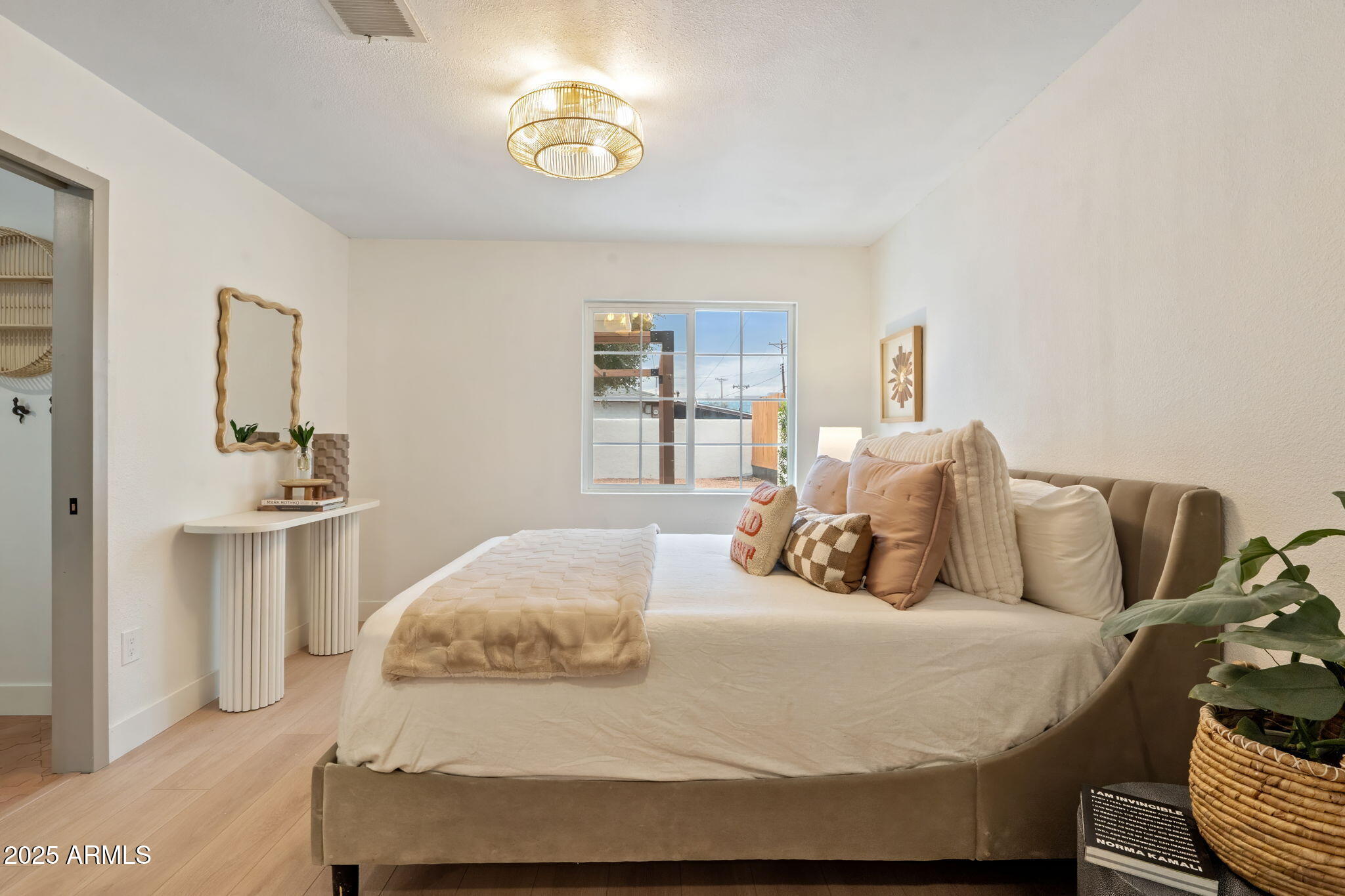 7255 East Coronado Road Scottsdale, AZ 85257 - Photo 20 of 55 a bedroom with a bed and a chandelier