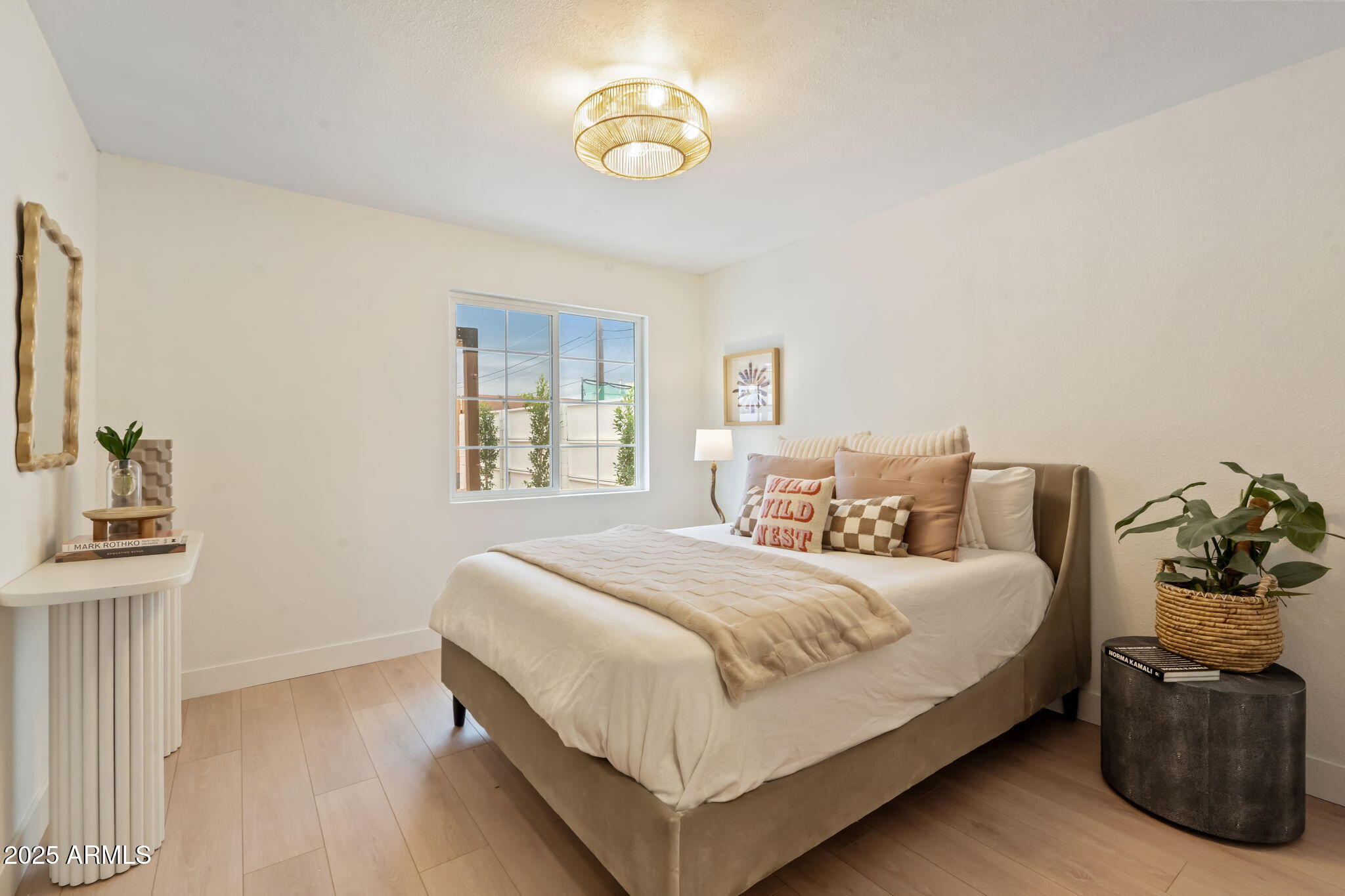 7255 East Coronado Road Scottsdale, AZ 85257 - Photo 21 of 55 a bedroom with a bed and a chandelier