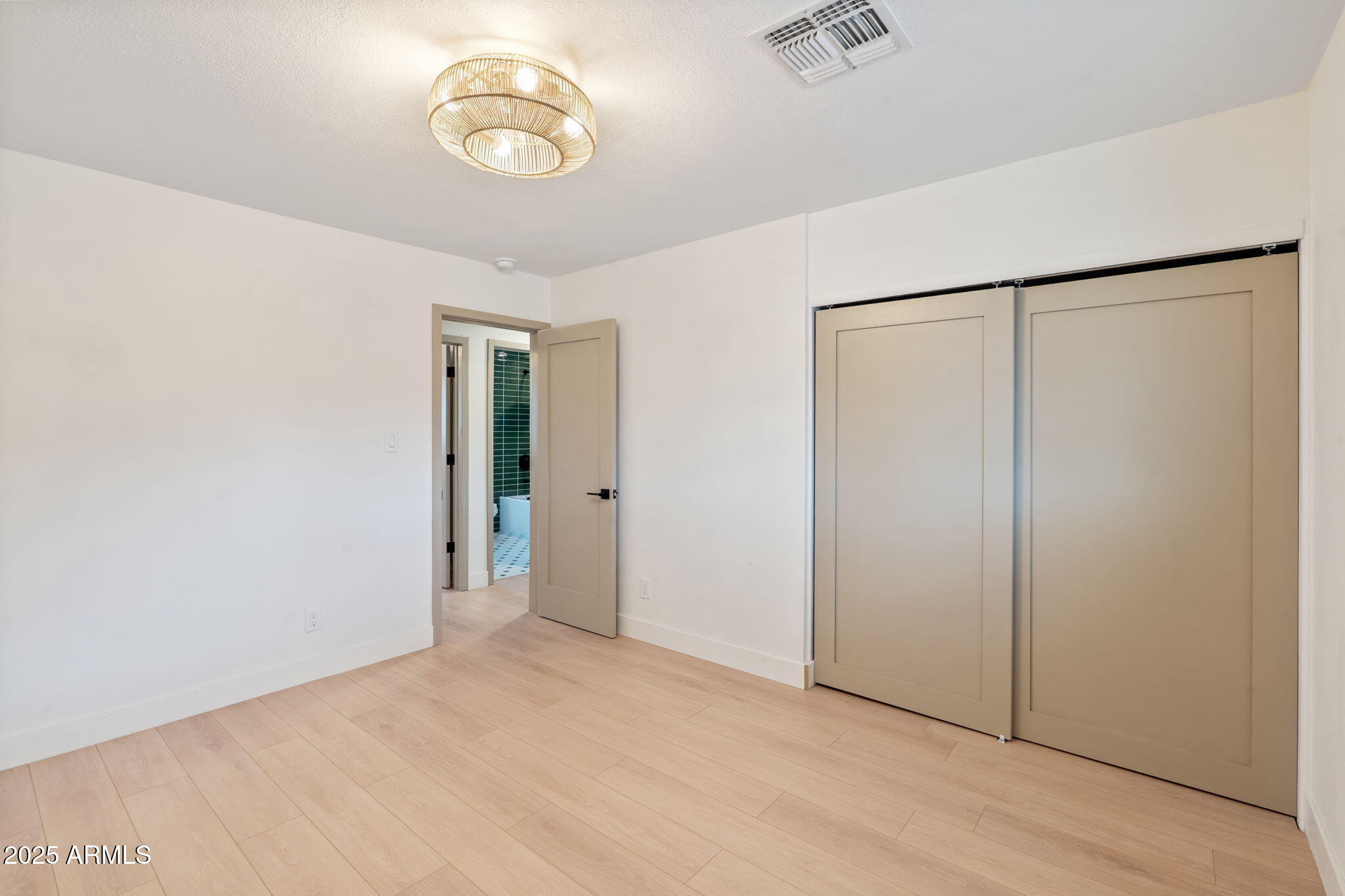 7255 East Coronado Road Scottsdale, AZ 85257 - Photo 30 of 55 an empty room with closet and wooden floor