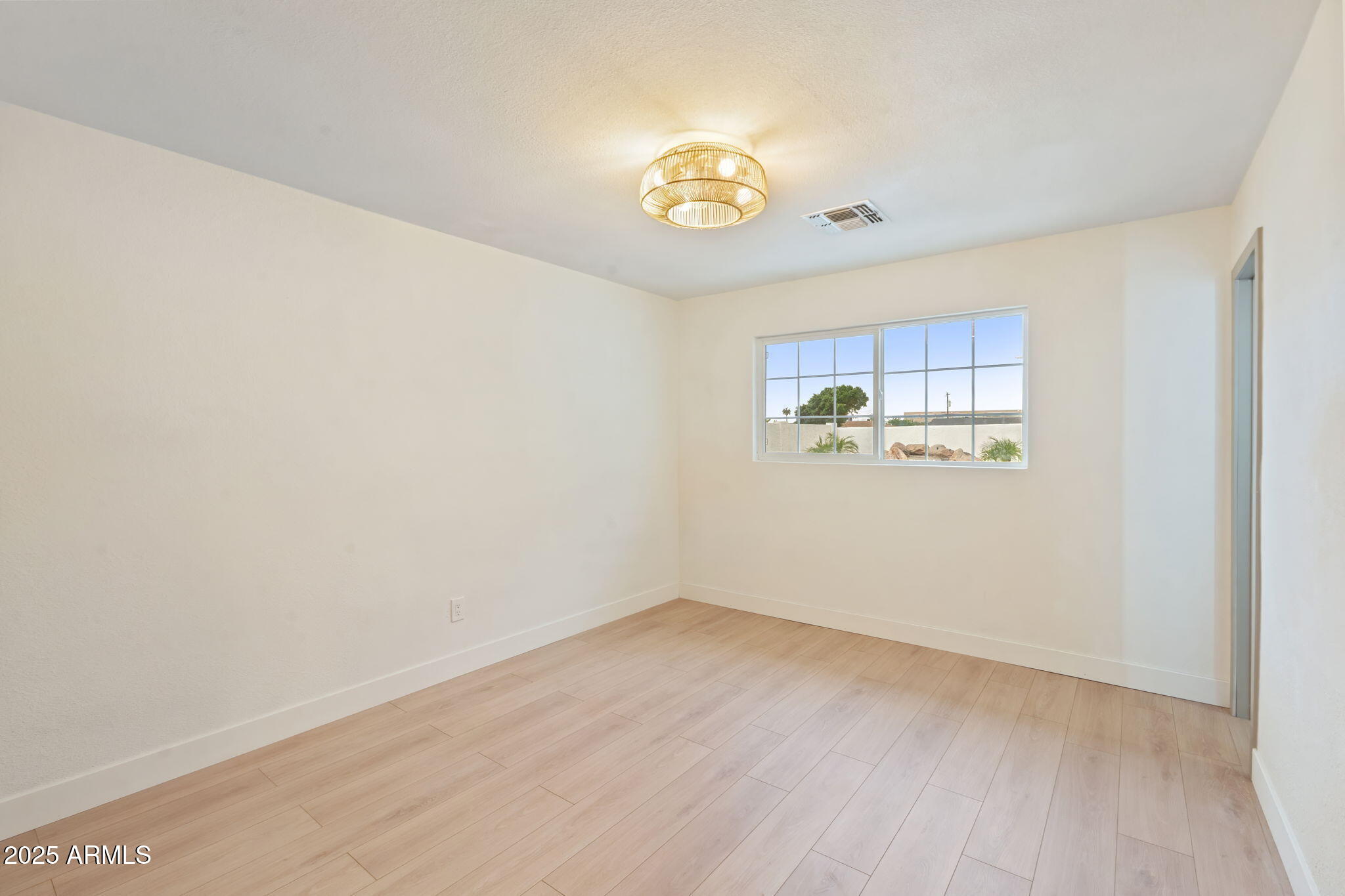 7255 East Coronado Road Scottsdale, AZ 85257 - Photo 32 of 55 a view of room with wooden floor and window