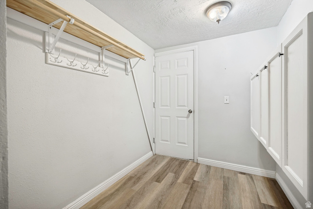 5529 Ridge Hollow Way Kearns, UT 84118 - Photo 12 of 23 Entry area featuring wood-finish flooring and light gray walls