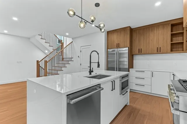 a kitchen with a sink appliances and cabinets