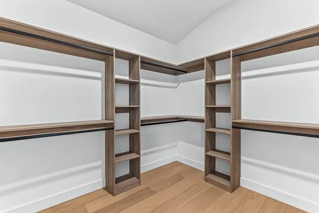 a view of walk in closet with empty racks