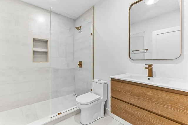 a bathroom with a toilet a sink and shower