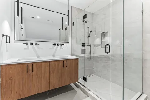 a bathroom with a shower and a sink
