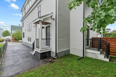a view of a house with a yard and deck