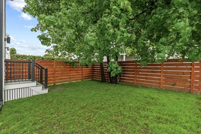 a view of a deck with a small yard