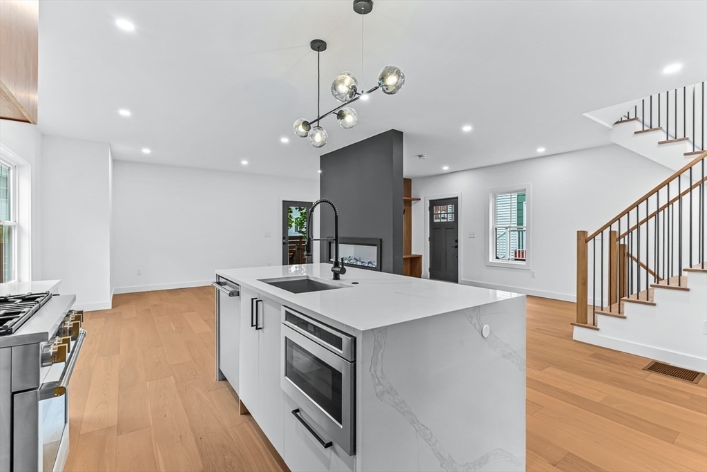 11 Bonner Avenue, Unit 2 Medford, MA 02155 - Photo 10 of 33 a kitchen with a stove and a wooden floor