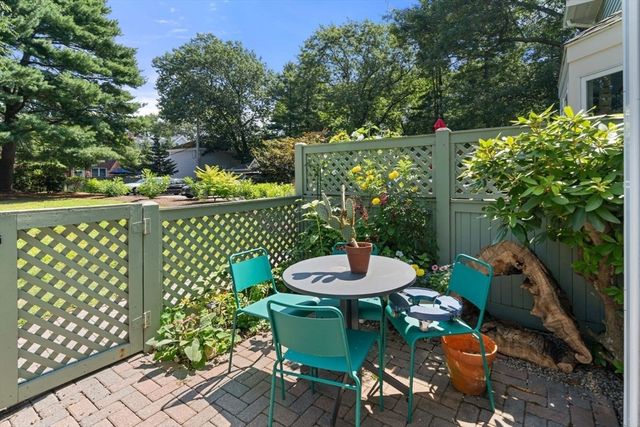 a view of a chairs and table in patio
