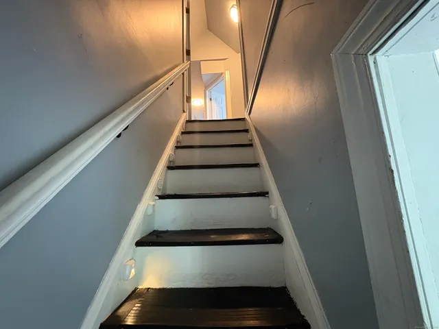 a bathroom with a toilet and a mirror