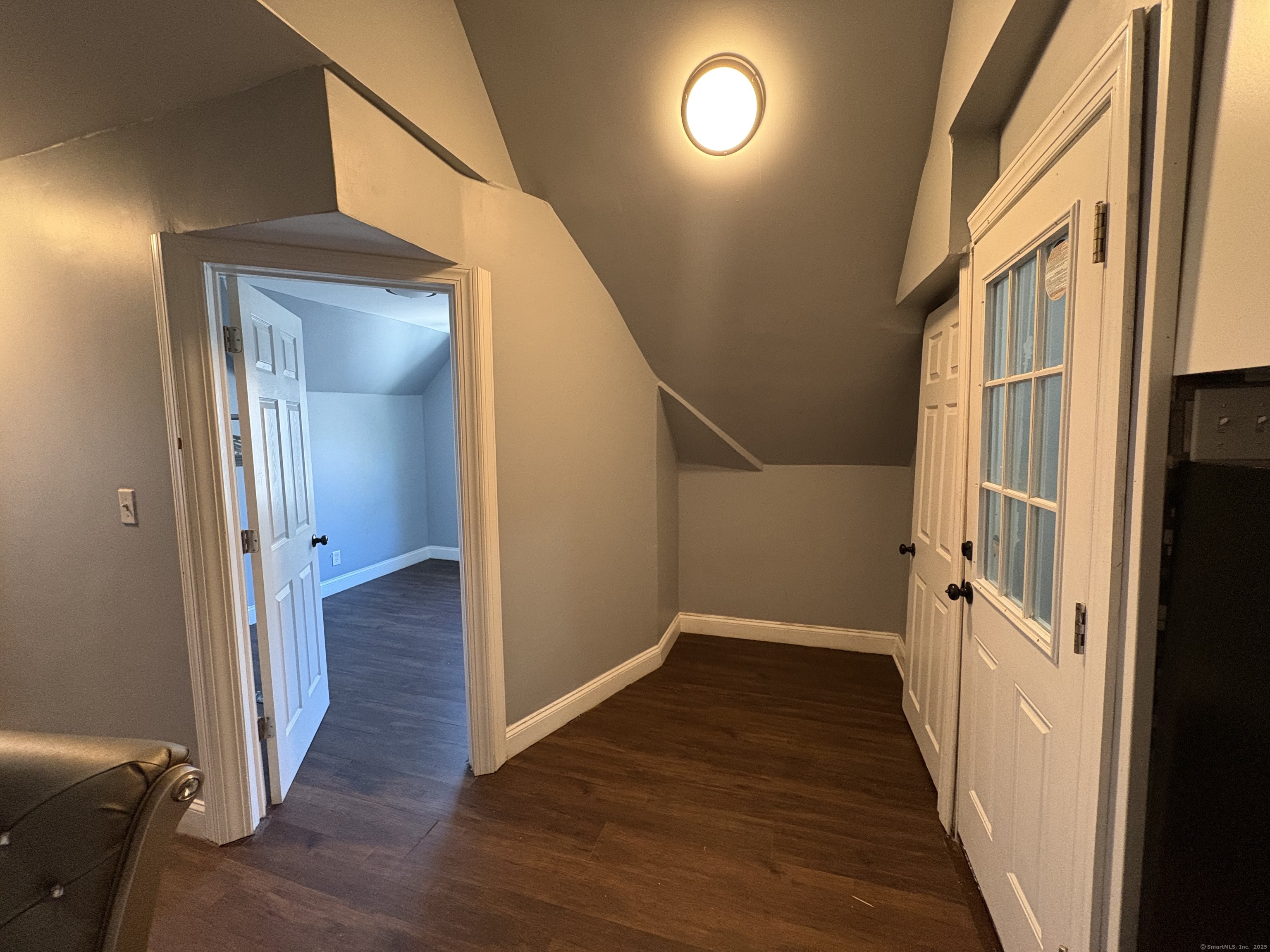 679 Shelton Street, Unit 2 Bridgeport, CT 06608 - Photo 16 of 25 a view of a hallway with wooden floor and staircase