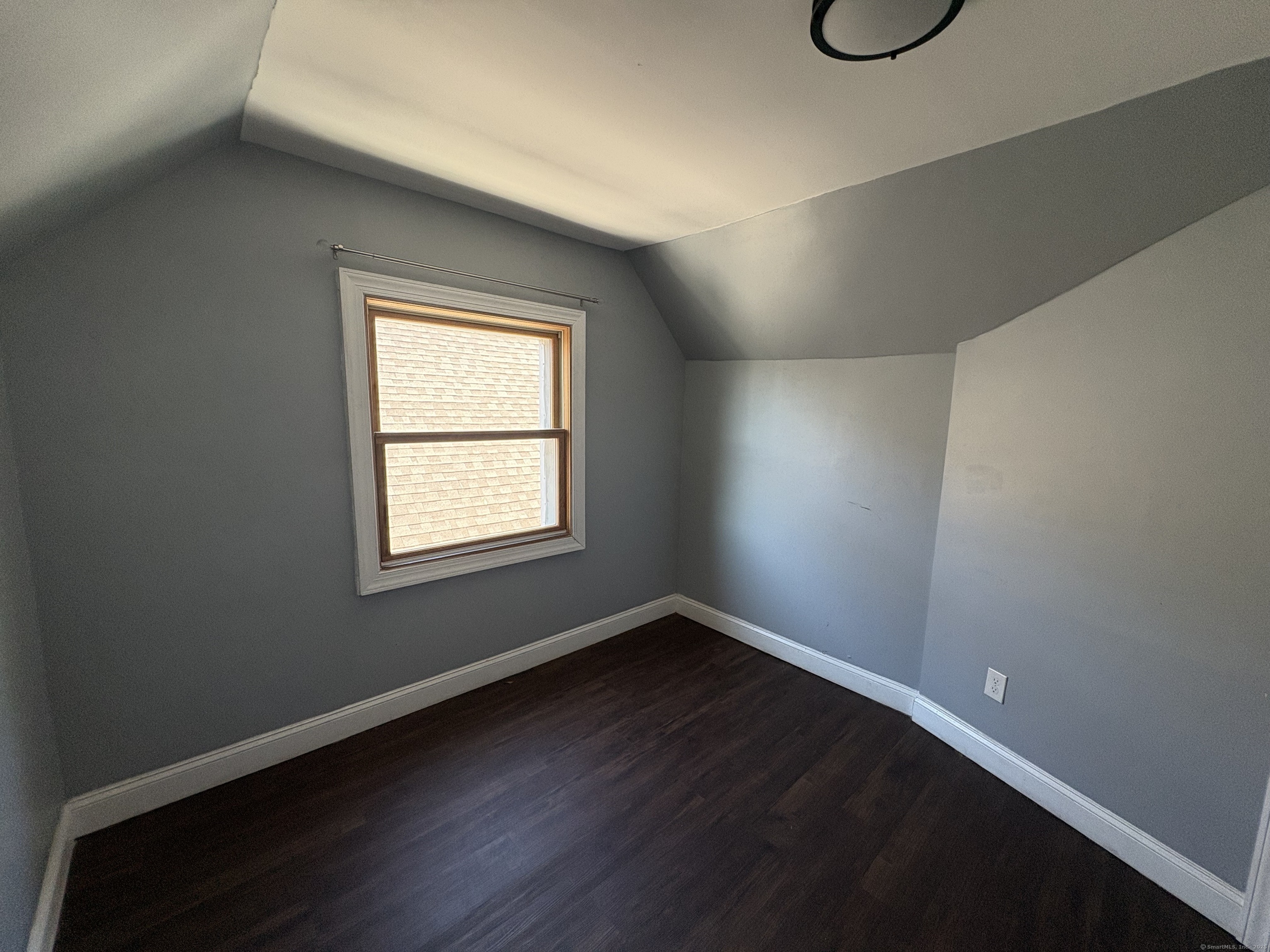 679 Shelton Street, Unit 2 Bridgeport, CT 06608 - Photo 17 of 25 an empty room with wooden floor and windows