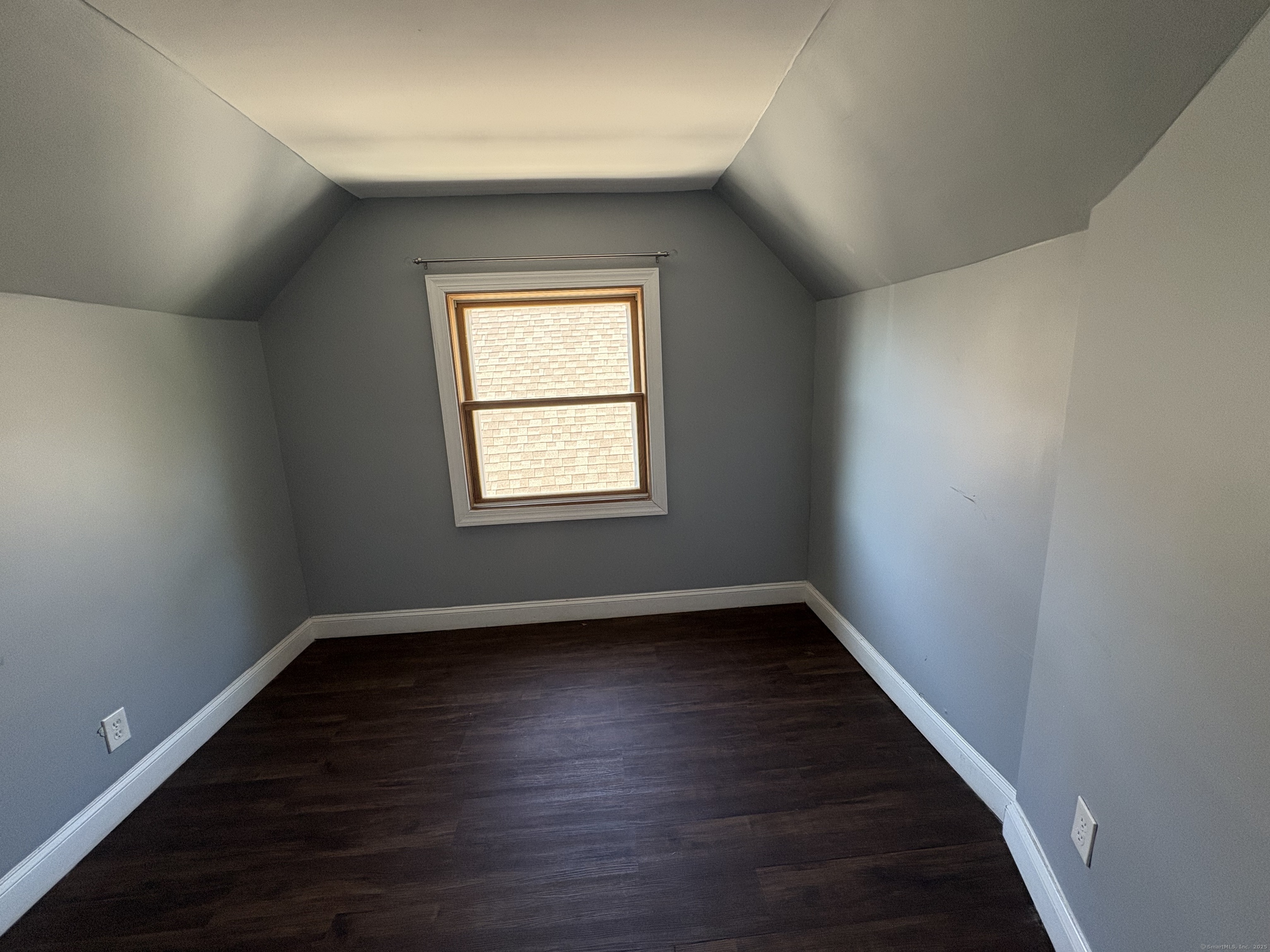 679 Shelton Street, Unit 2 Bridgeport, CT 06608 - Photo 24 of 25 an empty room with wooden floor and windows