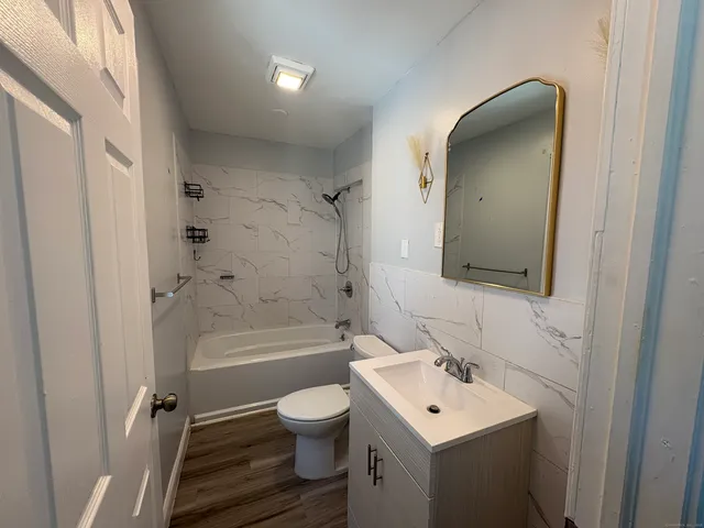 a bathroom with a toilet a sink and bathtub