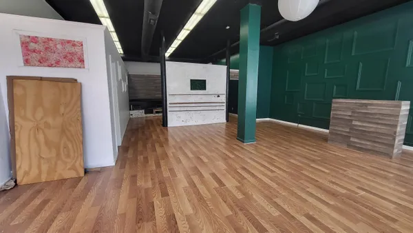 a view of a hallway with wooden floor and entryway