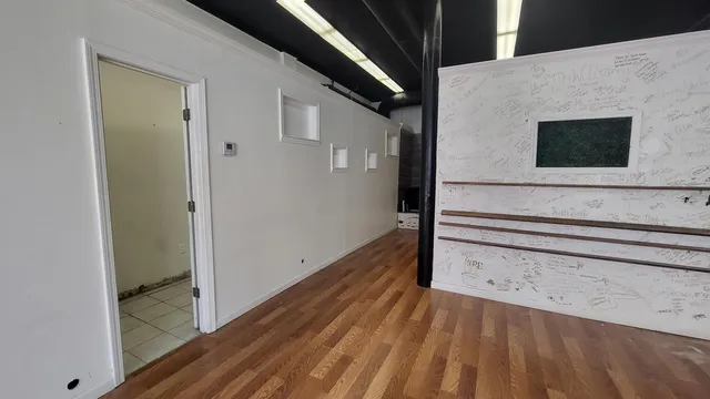 a view of wooden floor and windows in a room
