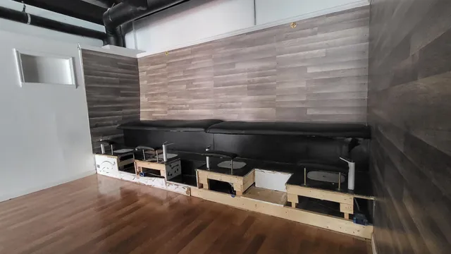 a view of room with wooden floor and furniture