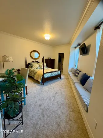 a bedroom with furniture and a flat screen tv