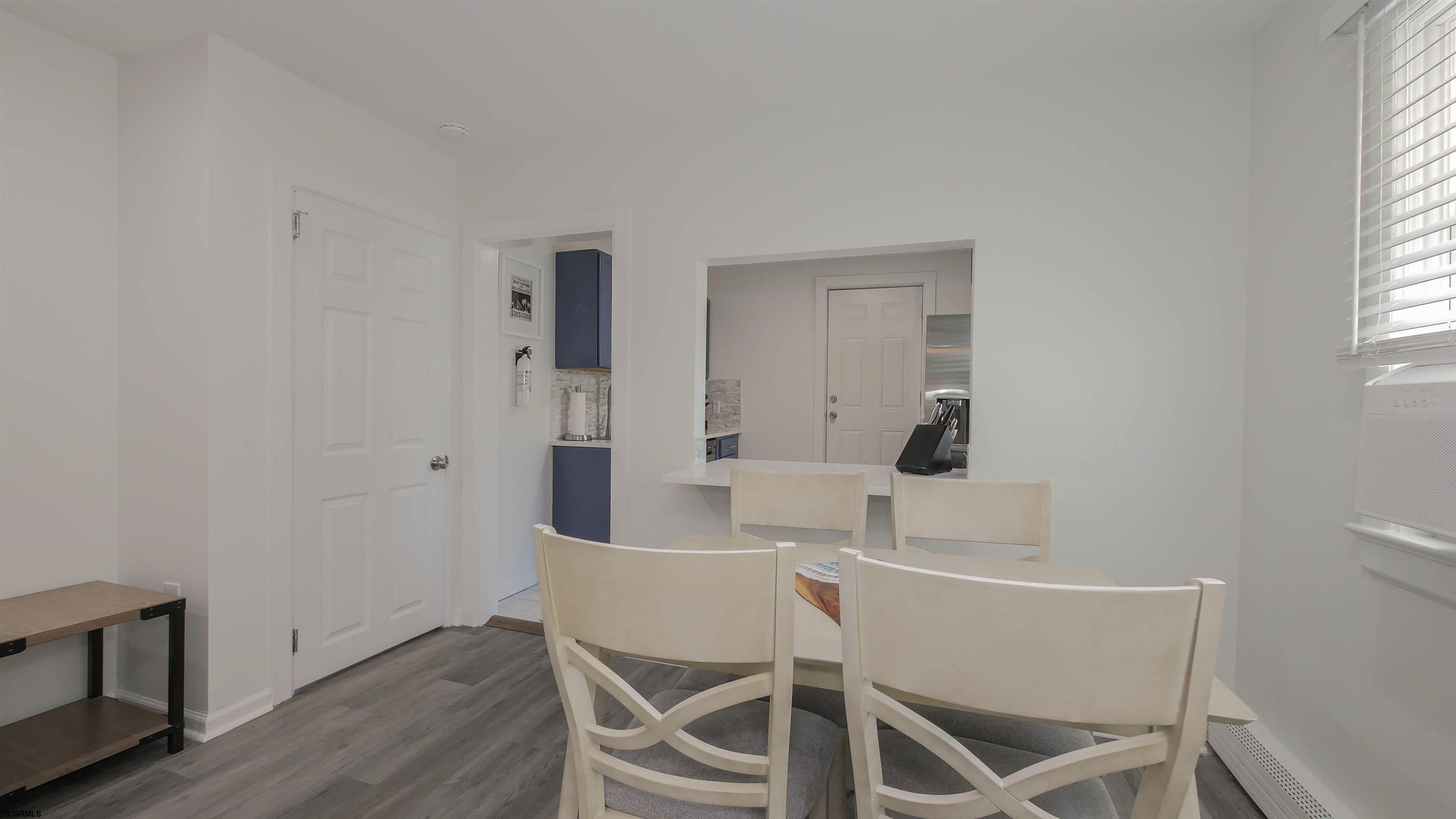 11 South Washington Avenue, Unit 2 Margate City, NJ 08402 - Photo 11 of 35 a view of a dining room with furniture and wooden floor