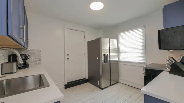 a kitchen with refrigerator and window