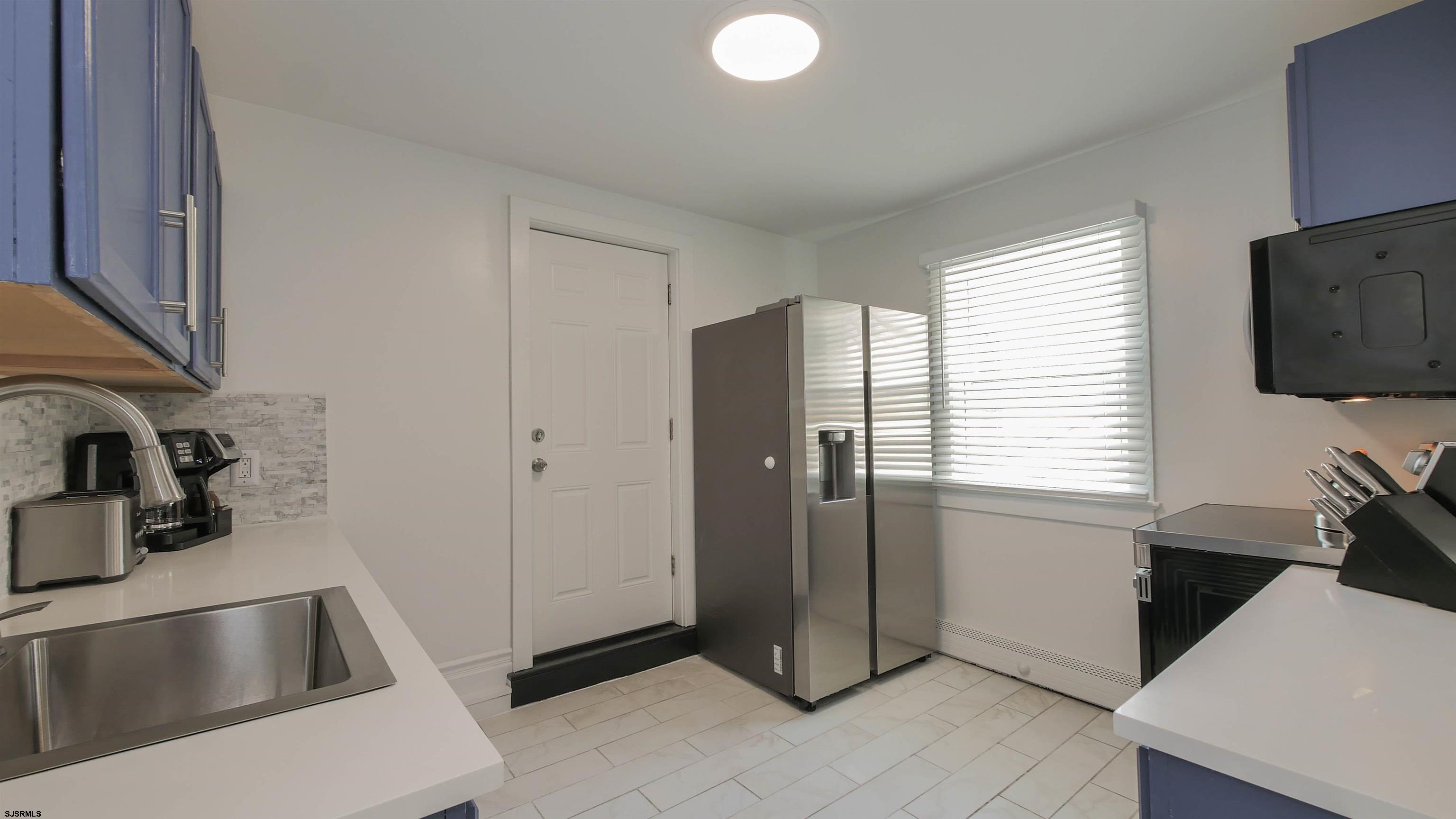 11 South Washington Avenue, Unit 2 Margate City, NJ 08402 - Photo 14 of 35 a kitchen with refrigerator and window