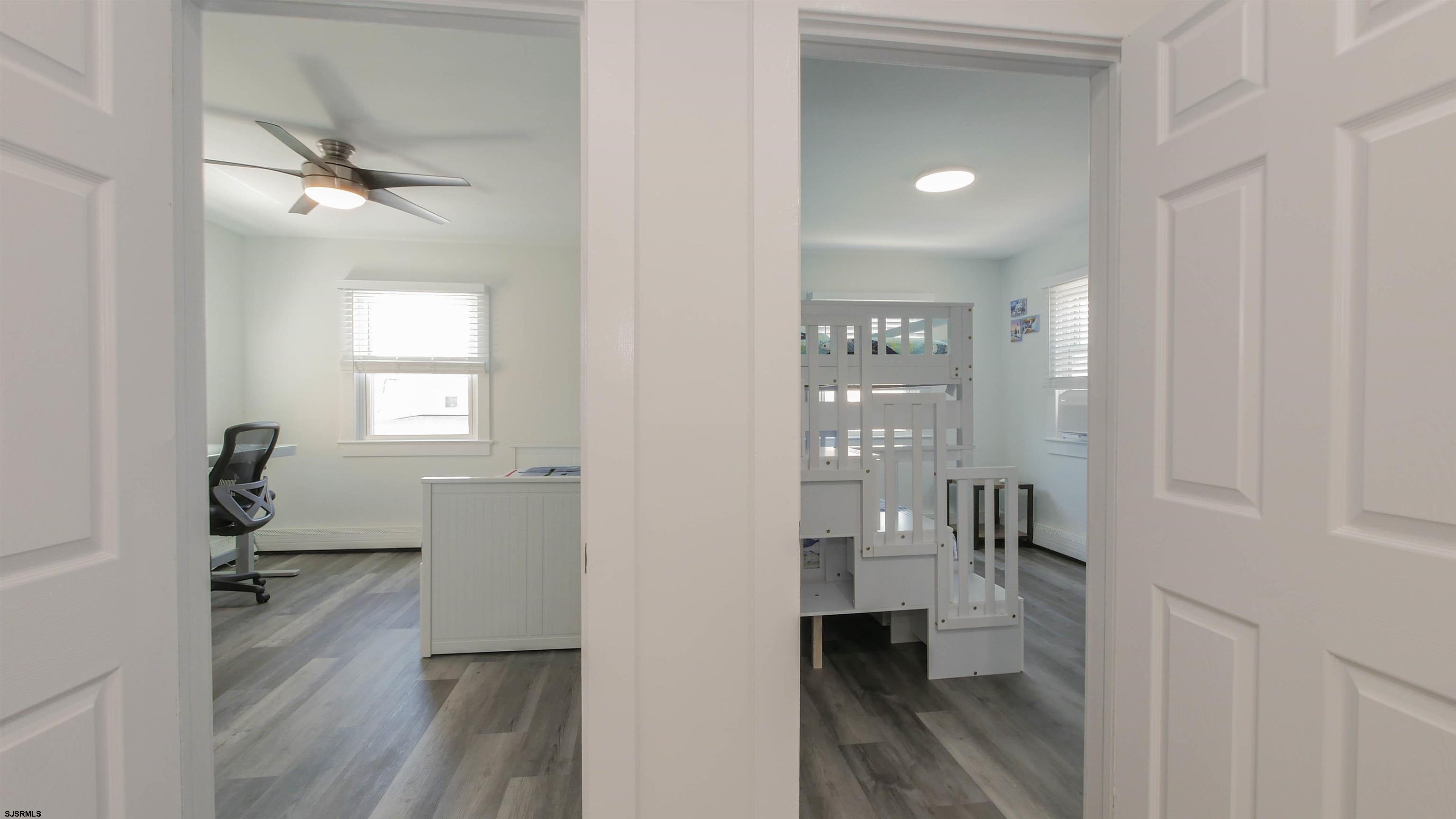 11 South Washington Avenue, Unit 2 Margate City, NJ 08402 - Photo 16 of 35 a bathroom with a sink and glass door