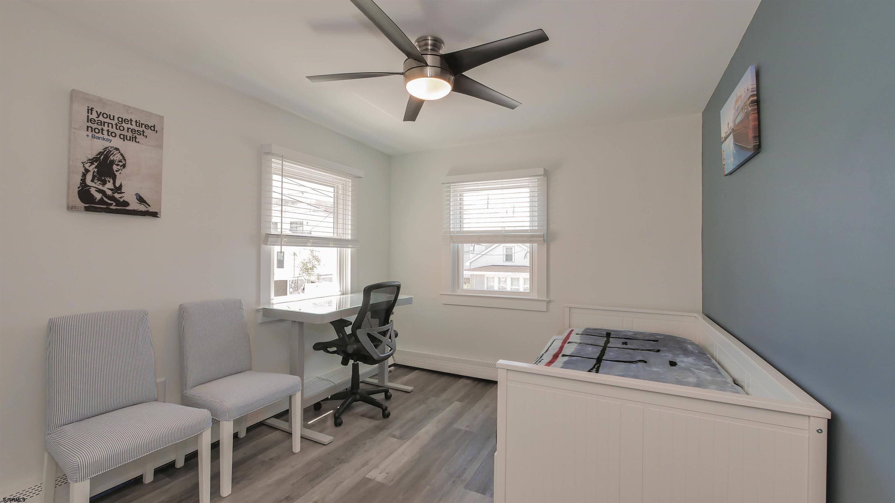 11 South Washington Avenue, Unit 2 Margate City, NJ 08402 - Photo 17 of 35 a living room with a stove and a window