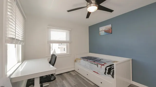 a living room with hard wood floors and a window