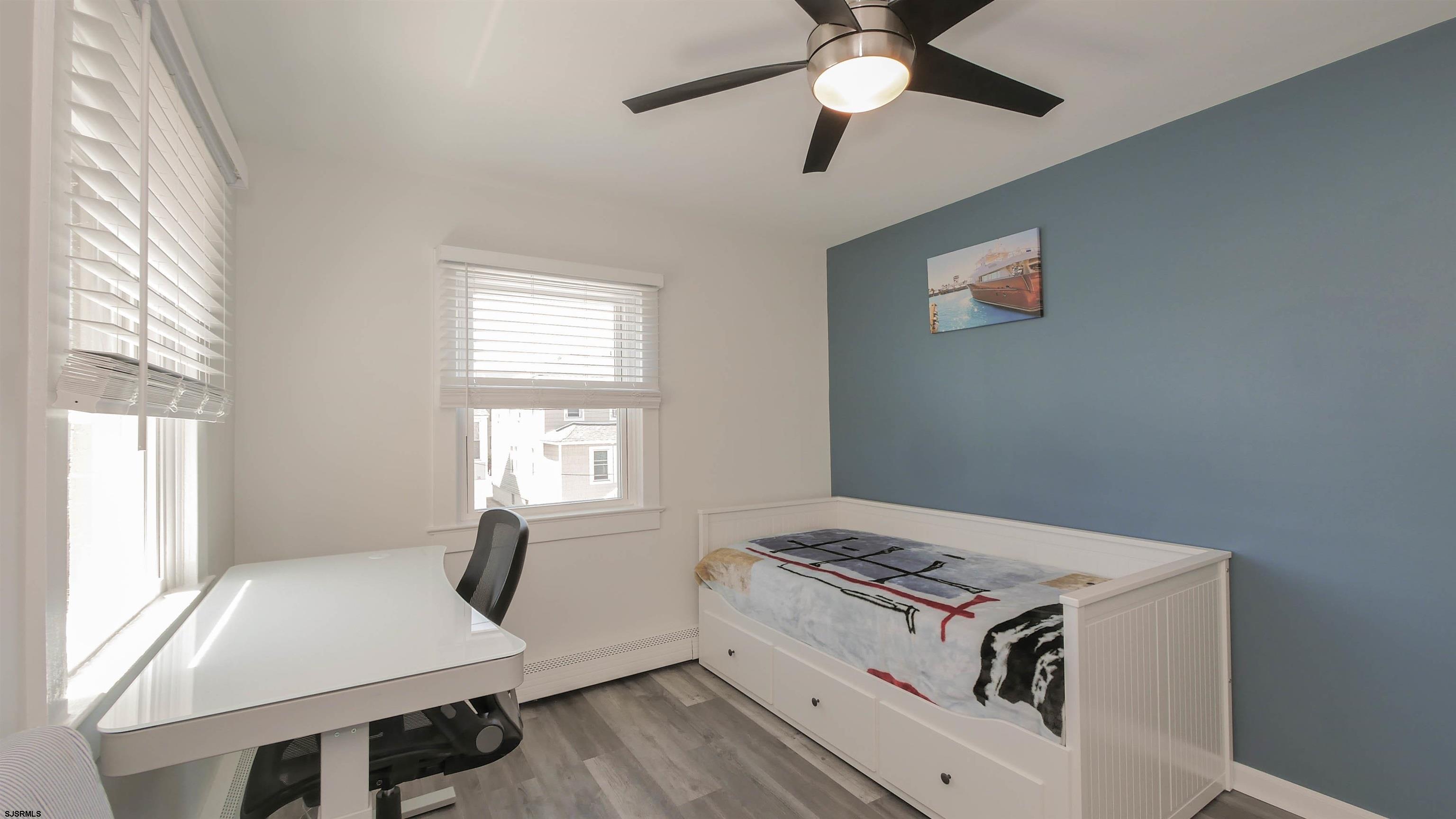 11 South Washington Avenue, Unit 2 Margate City, NJ 08402 - Photo 18 of 35 a living room with hard wood floors and a window