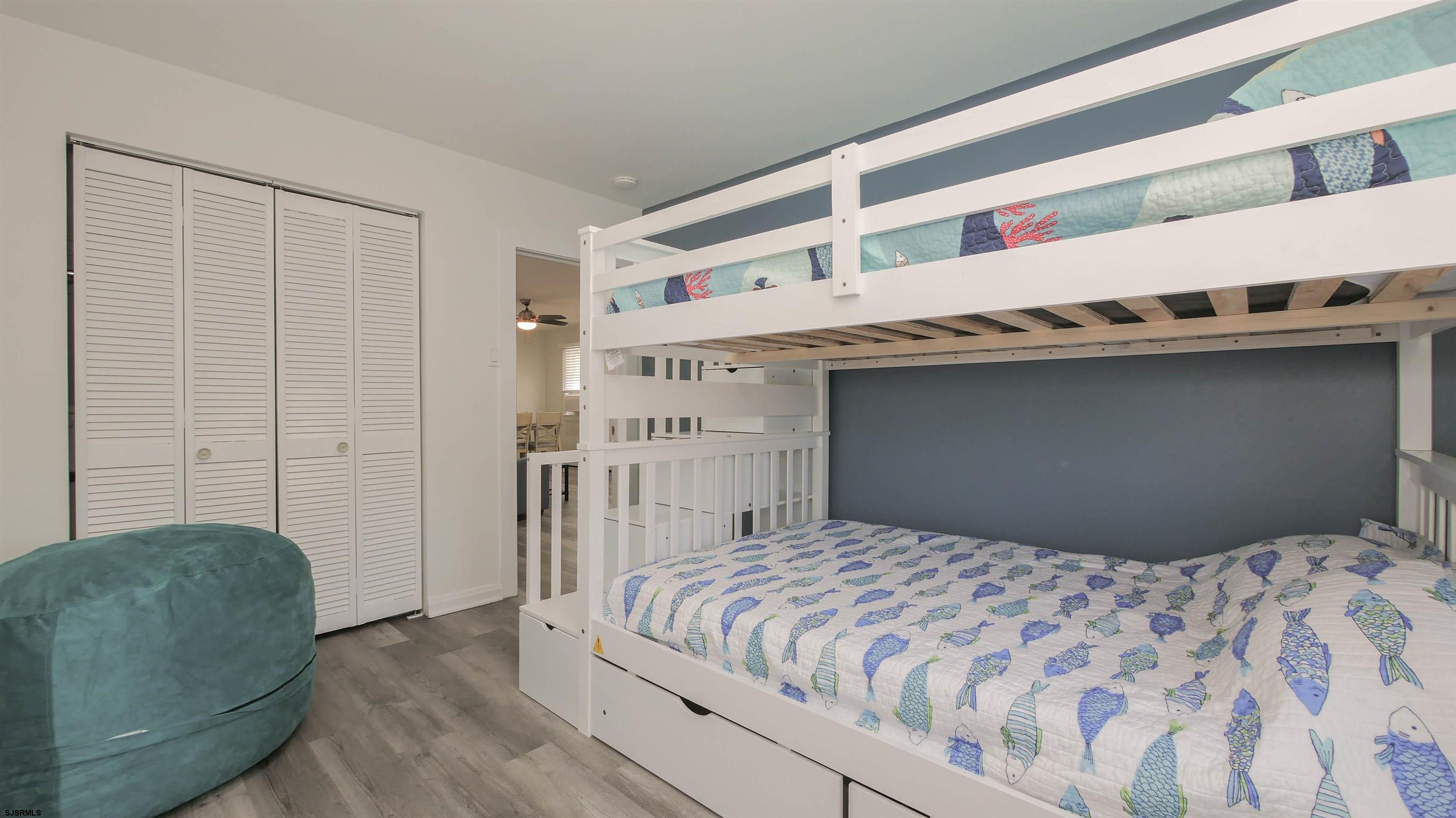 11 South Washington Avenue, Unit 2 Margate City, NJ 08402 - Photo 22 of 35 a bedroom with a bed and a cabinets