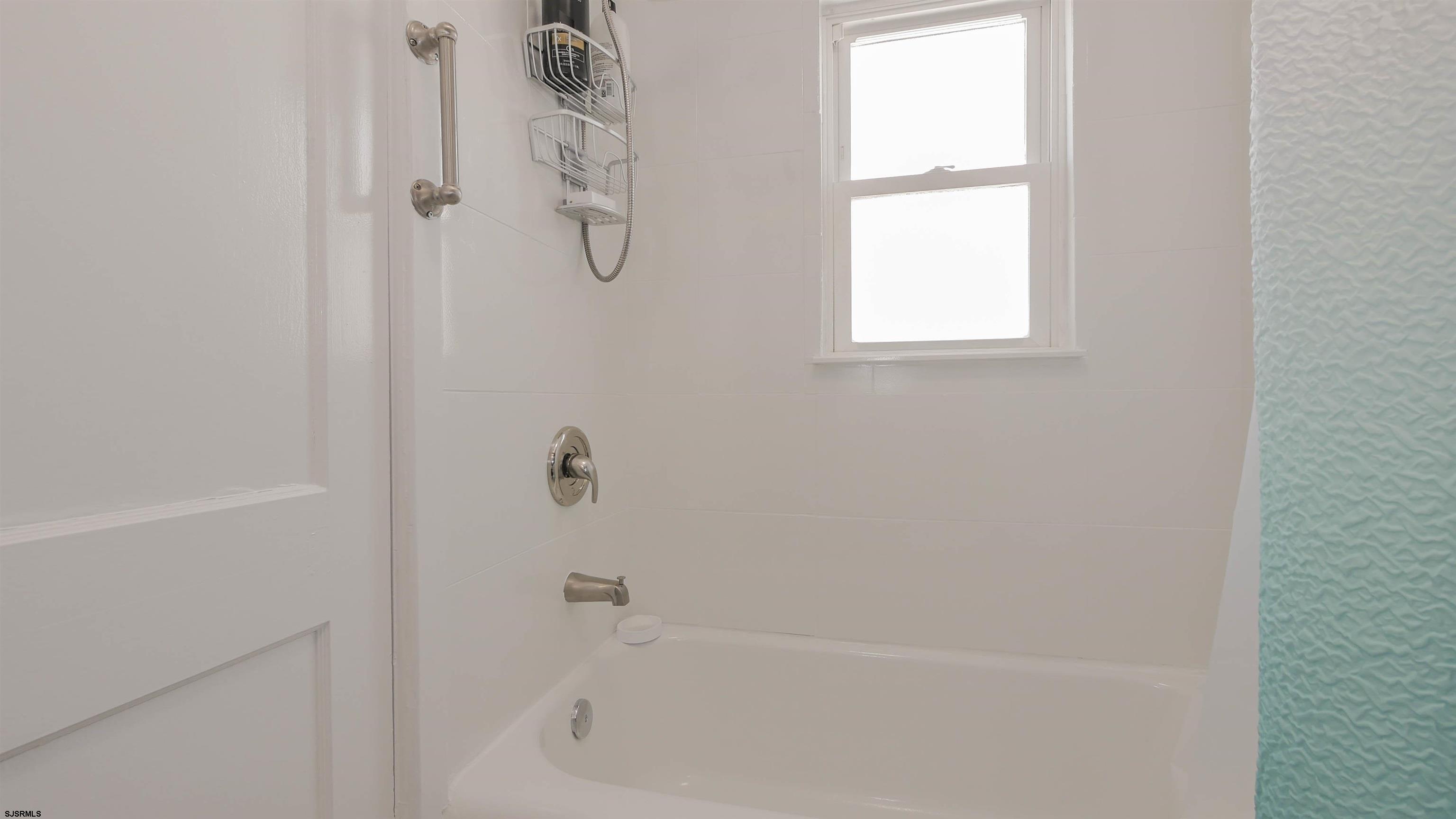 11 South Washington Avenue, Unit 2 Margate City, NJ 08402 - Photo 26 of 35 a bathroom with a bathtub