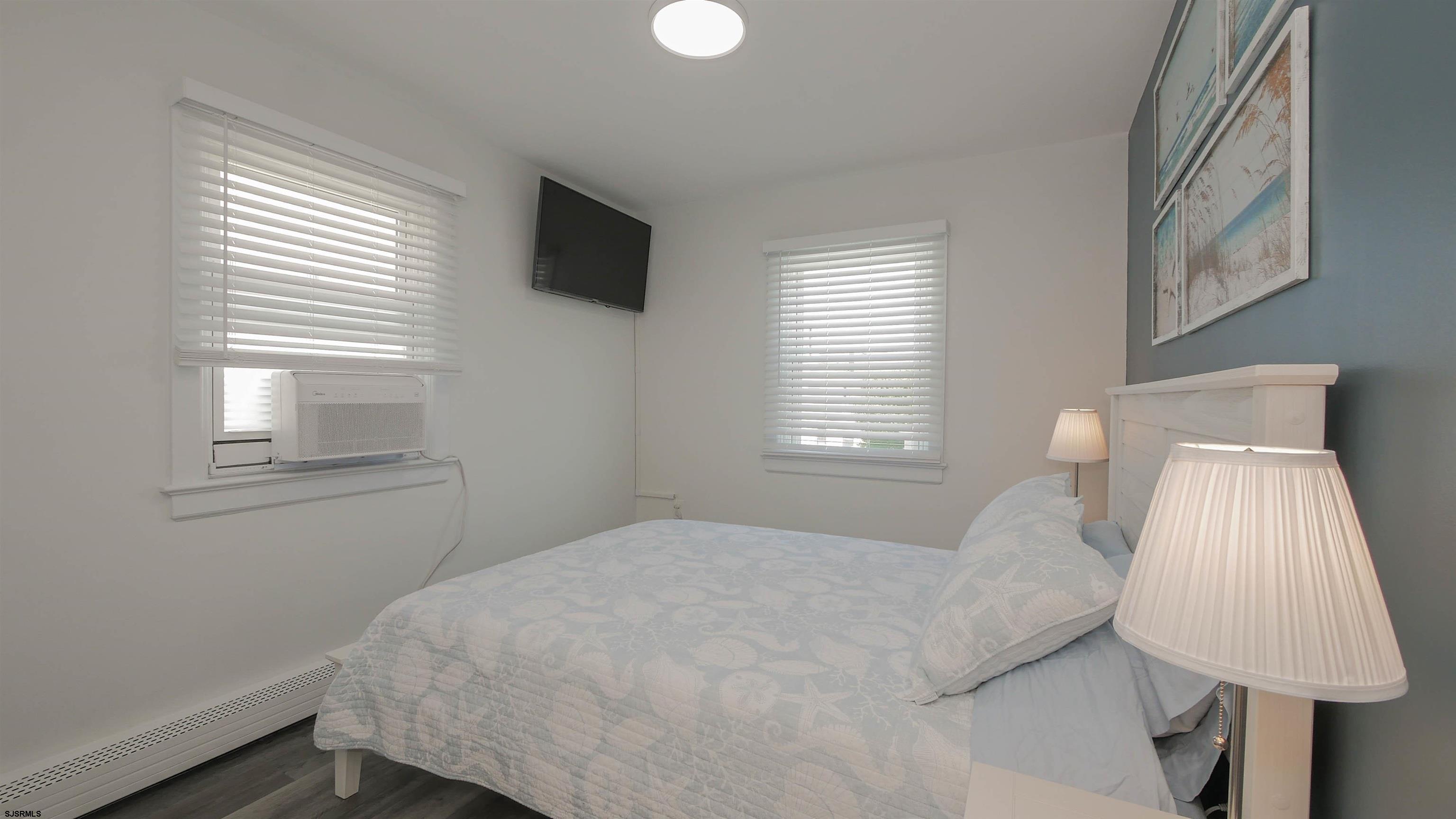 11 South Washington Avenue, Unit 2 Margate City, NJ 08402 - Photo 27 of 35 a bedroom with a bed and a window