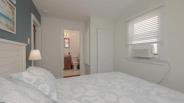 a white toilet sitting next to a white sink
