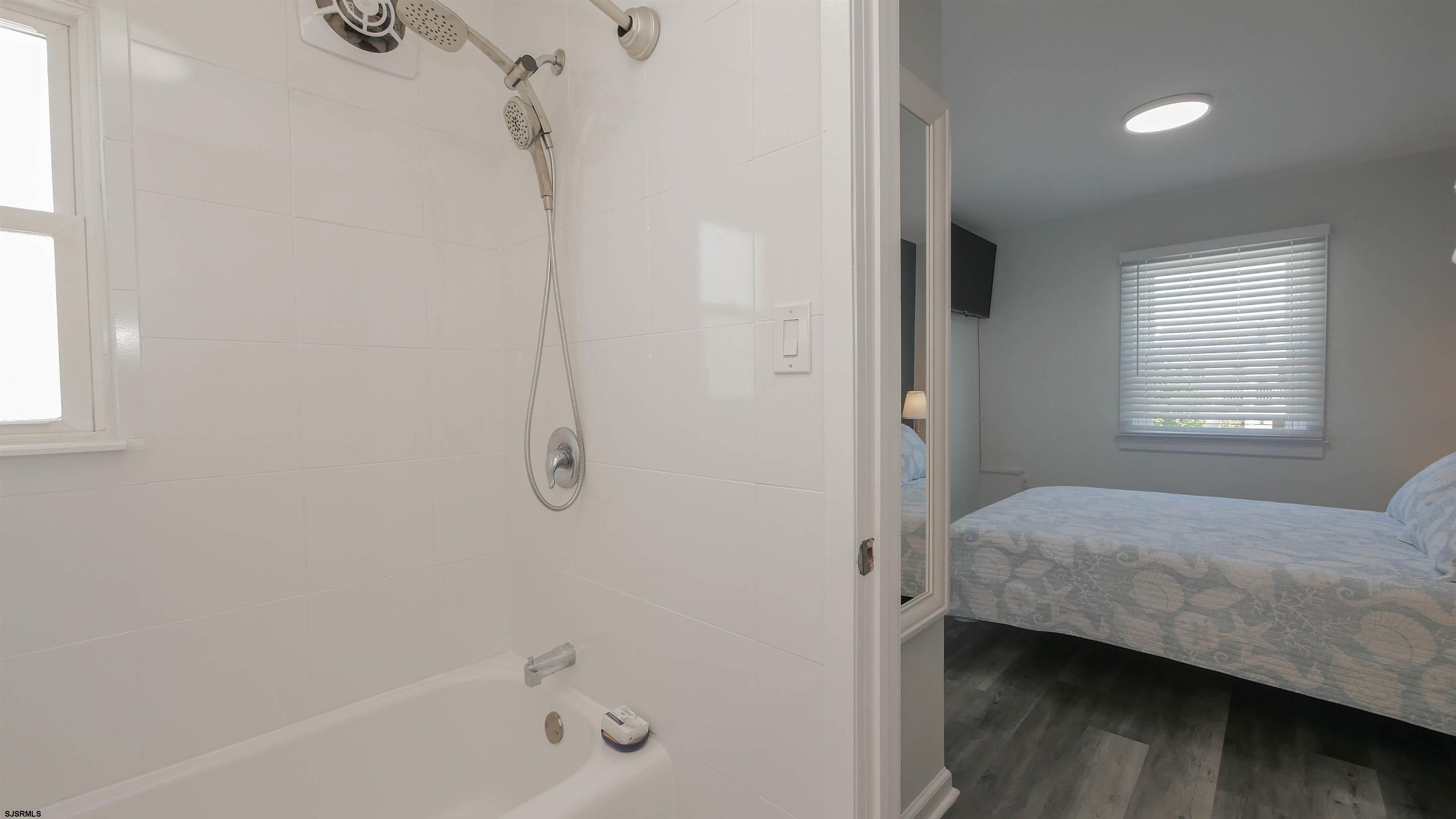 11 South Washington Avenue, Unit 2 Margate City, NJ 08402 - Photo 31 of 35 a bedroom with a bed and a window