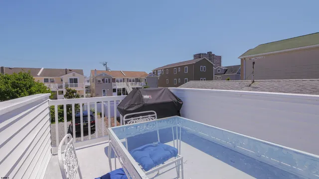 a view of a house with a patio and a yard