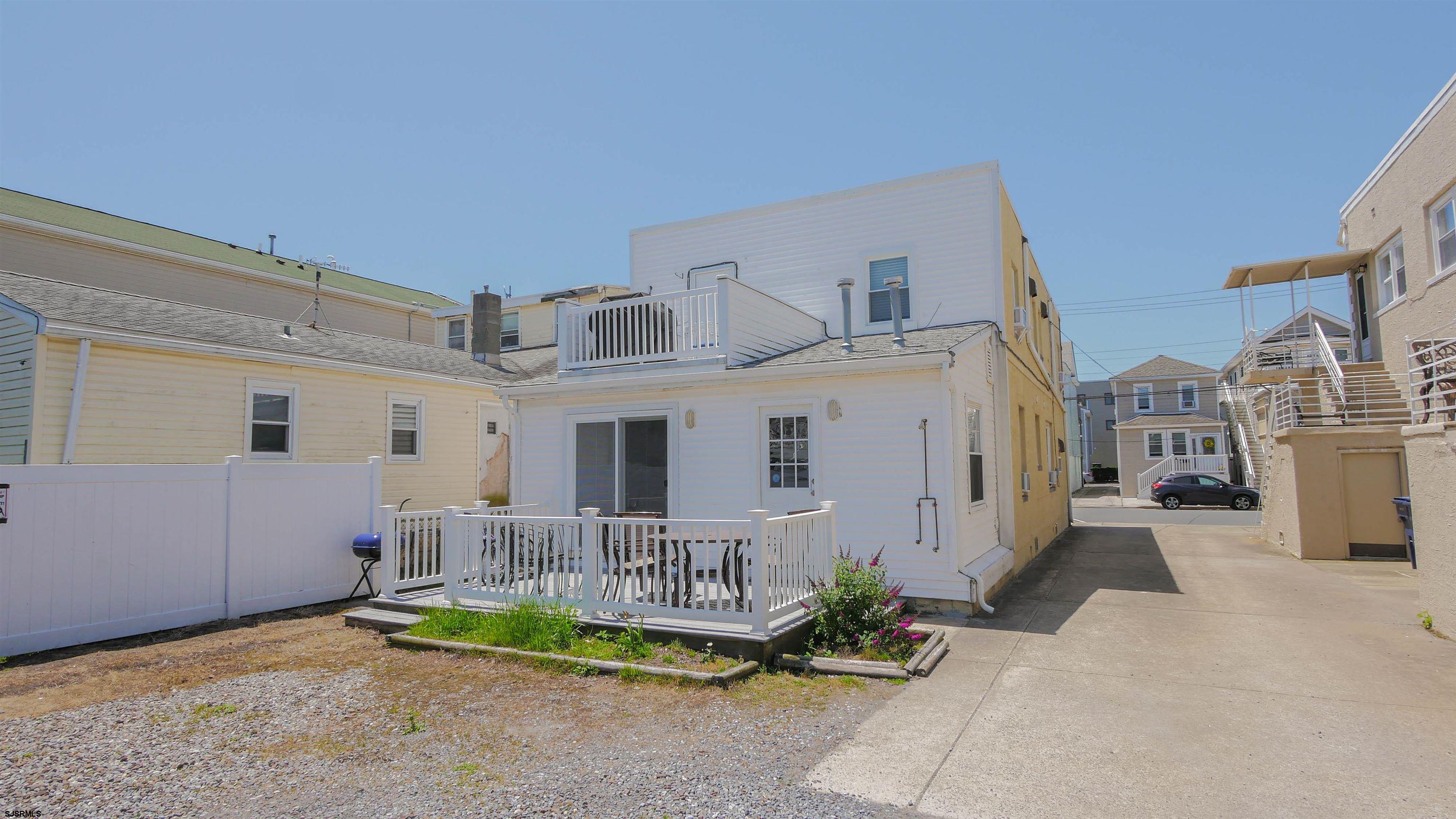 11 South Washington Avenue, Unit 2 Margate City, NJ 08402 - Photo 34 of 35 a view of a house with a patio and a yard