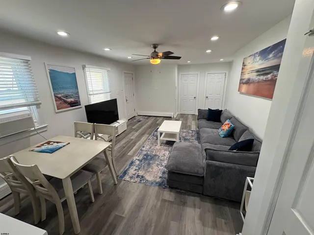 a living room with furniture and a wooden floor