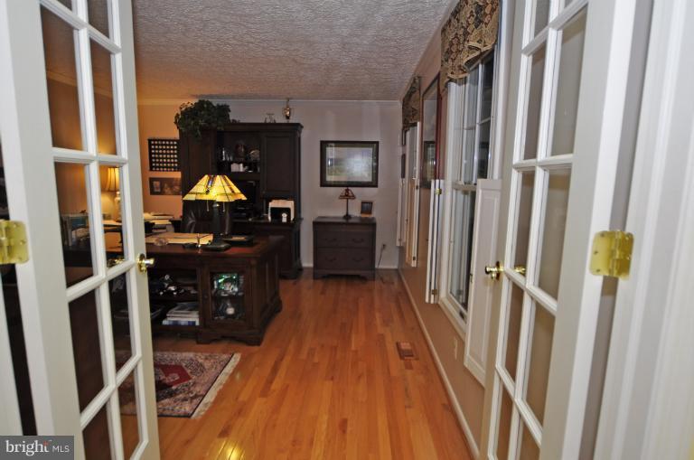 1943 Barton Hill Road Reston, VA 20191 - Photo 16 of 28 a view of a hallway with wooden floor and furniture