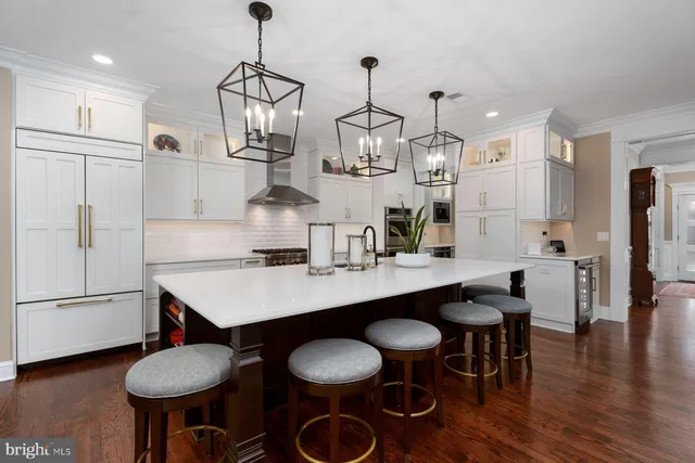 a kitchen with stainless steel appliances granite countertop a sink and a refrigerator
