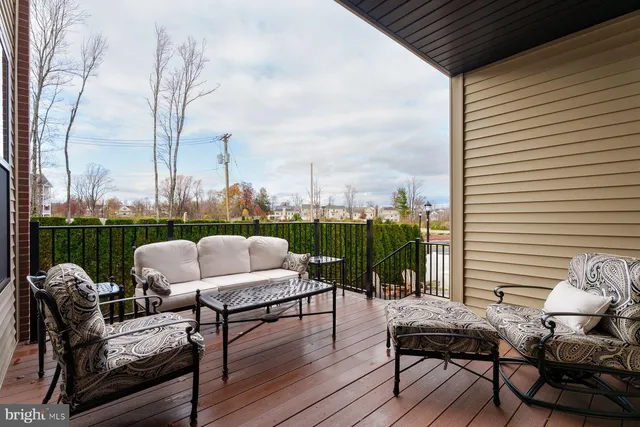 a view of deck with table and chairs and wooden floor